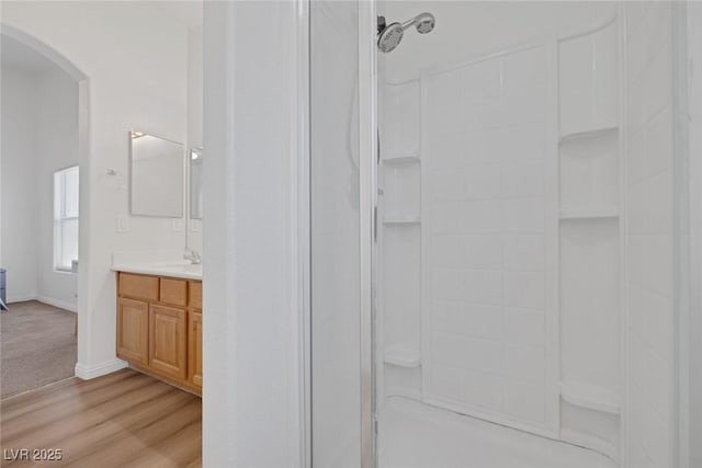 8639 Horizon Wind Ave Unit 102, Las Vegas, NV 89178 - bathroom with a walk in shower, vanity, and wood finished floors