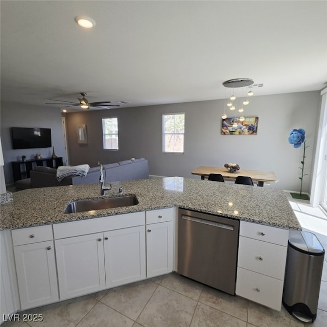 7990 Formitch Ct, Las Vegas, NV 89166 - kitchen featuring stainless steel dishwasher, white cabinetry, light stone countertops, ceiling fan, and light tile patterned floors