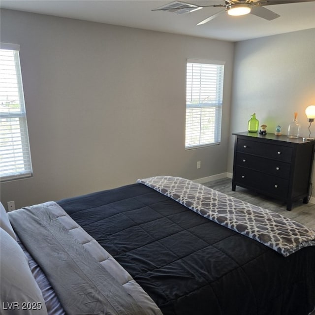 7990 Formitch Ct, Las Vegas, NV 89166 - bedroom featuring multiple windows, light wood-type flooring, and a ceiling fan