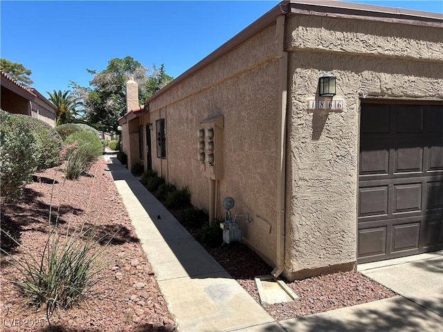 1866 Camino Verde Ln, Las Vegas, NV 89119 - view of side of home featuring stucco siding and a garage
