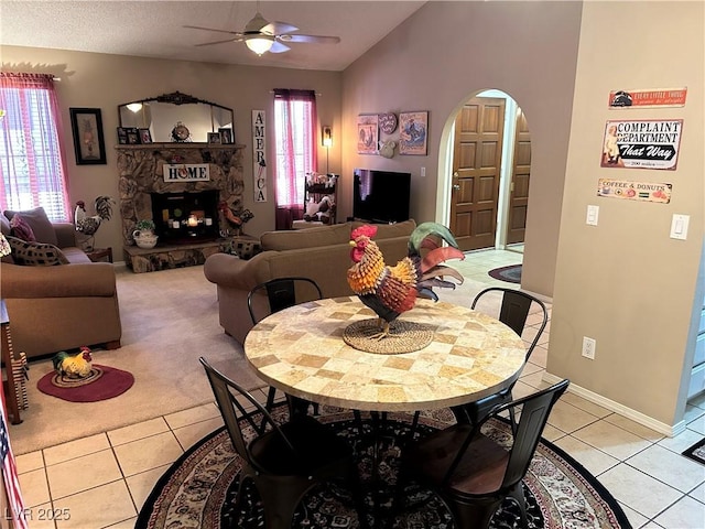 1866 Camino Verde Ln, Las Vegas, NV 89119 - dining space featuring a ceiling fan, arched walkways, plenty of natural light, light tile patterned floors, and vaulted ceiling