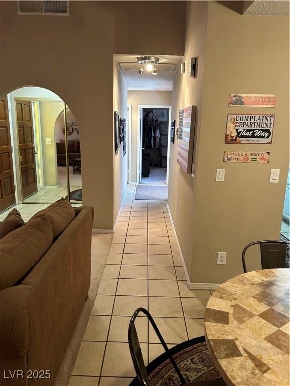 1866 Camino Verde Ln, Las Vegas, NV 89119 - hallway with light tile patterned floors and arched walkways