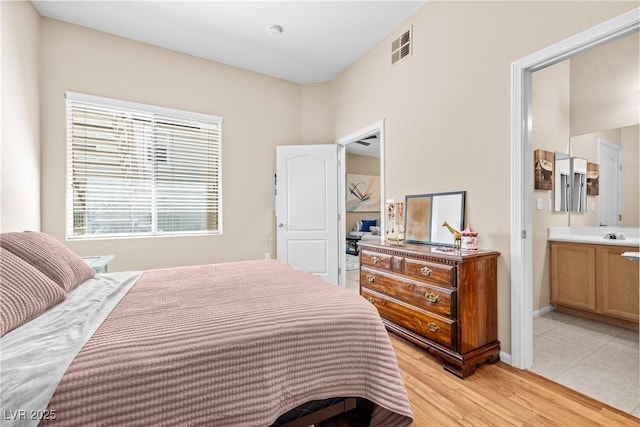 3451 Desert Cliff St Unit 103, Las Vegas, NV 89129 - bedroom featuring ensuite bath and light wood-style flooring