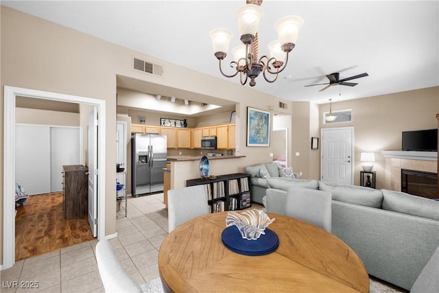 3451 Desert Cliff St Unit 103, Las Vegas, NV 89129 - dining space with light tile patterned floors, a ceiling fan, a chandelier, and a fireplace