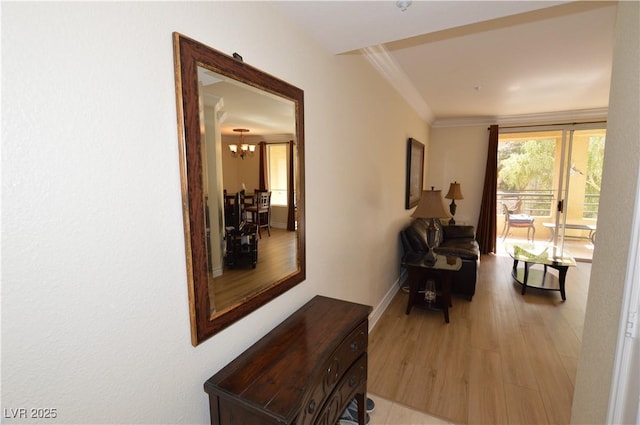 230 E Flamingo Rd Unit 229, Las Vegas, NV 89169 - hallway with a chandelier, light wood-style floors, and crown molding