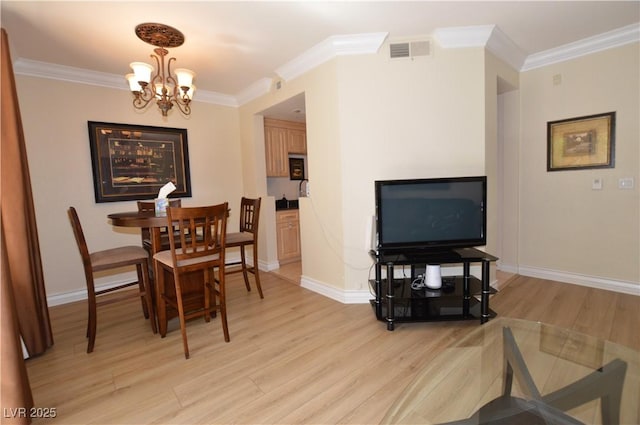 230 E Flamingo Rd Unit 229, Las Vegas, NV 89169 - dining room with light wood finished floors, a chandelier, and ornamental molding