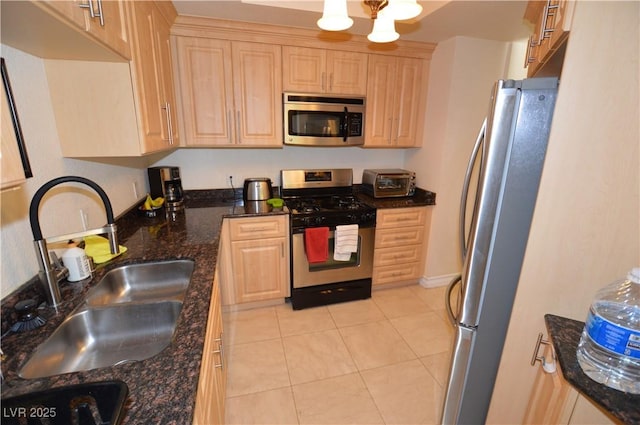 230 E Flamingo Rd Unit 229, Las Vegas, NV 89169 - kitchen featuring stainless steel appliances, light brown cabinets, light tile patterned floors, and dark stone counters
