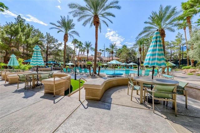 230 E Flamingo Rd Unit 229, Las Vegas, NV 89169 - view of patio / terrace featuring a community pool and outdoor dining space