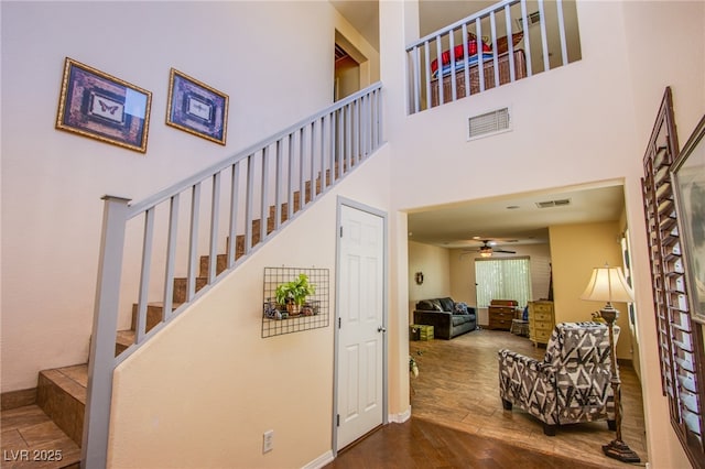 9022 Sosa Creek Ave, Las Vegas, NV 89149 - staircase with a towering ceiling, wood finished floors, and ceiling fan