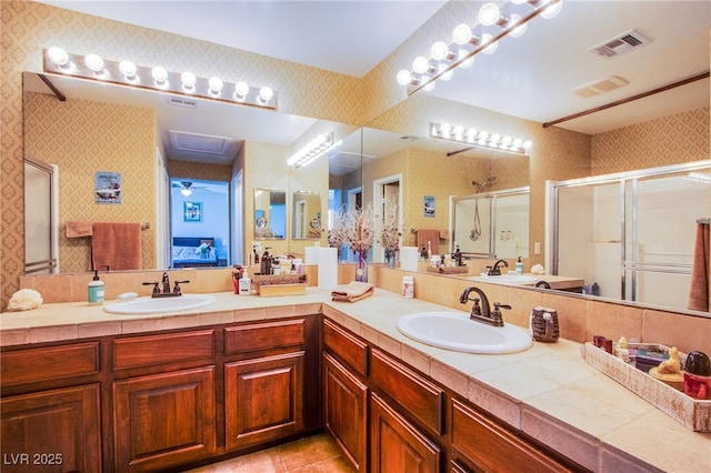9022 Sosa Creek Ave, Las Vegas, NV 89149 - full bathroom with wallpapered walls, a shower stall, double vanity, and tile patterned floors