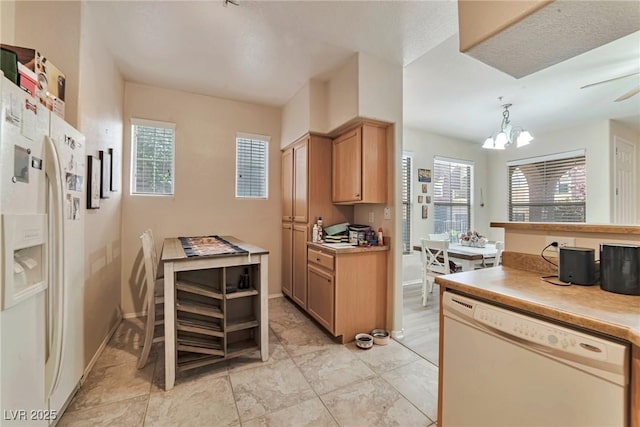 3975 N Hualapai Way Unit 121, Las Vegas, NV 89129 - kitchen featuring white appliances, a chandelier, light countertops, and decorative light fixtures