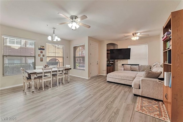 3975 N Hualapai Way Unit 121, Las Vegas, NV 89129 - living room featuring a ceiling fan, light wood-type flooring, and a chandelier