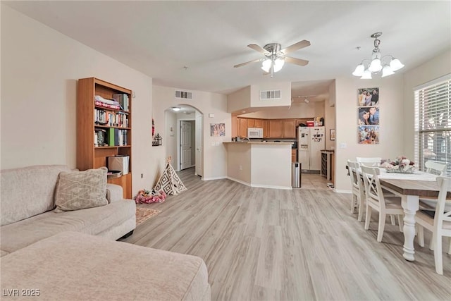 3975 N Hualapai Way Unit 121, Las Vegas, NV 89129 - living room featuring arched walkways, light wood-type flooring, ceiling fan, and a chandelier