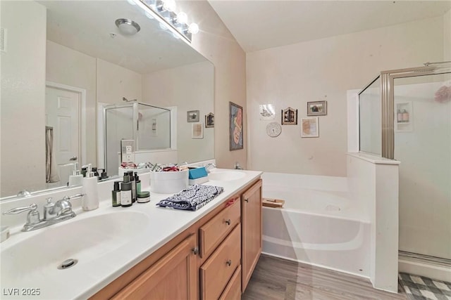 3975 N Hualapai Way Unit 121, Las Vegas, NV 89129 - bathroom with a stall shower, a bath, double vanity, and wood finished floors