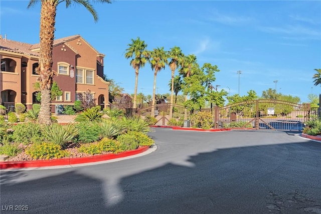 3975 N Hualapai Way Unit 121, Las Vegas, NV 89129 - view of asphalt street featuring curbs, a gate, and a gated entry