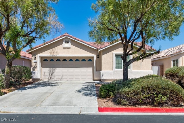 6740 Arctic Breeze St, North Las Vegas, NV 89084 - mediterranean / spanish house featuring stucco siding, a tile roof, an attached garage, and driveway