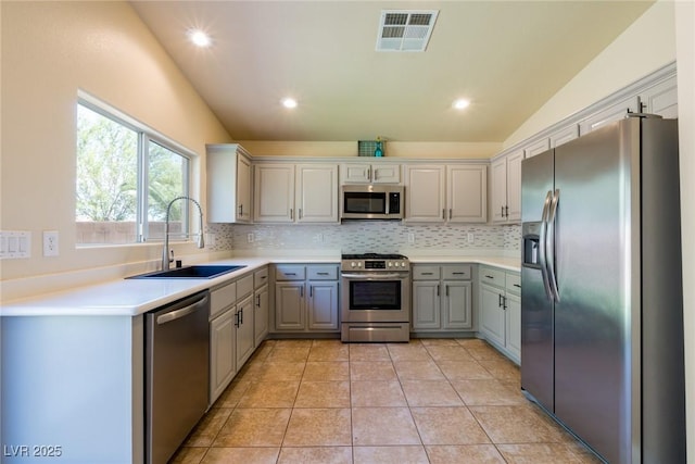 6740 Arctic Breeze St, North Las Vegas, NV 89084 - kitchen with appliances with stainless steel finishes, gray cabinets, backsplash, recessed lighting, and light tile patterned floors