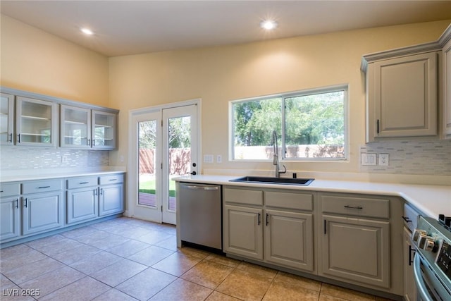 6740 Arctic Breeze St, North Las Vegas, NV 89084 - kitchen featuring stainless steel appliances, gray cabinets, decorative backsplash, glass insert cabinets, and recessed lighting