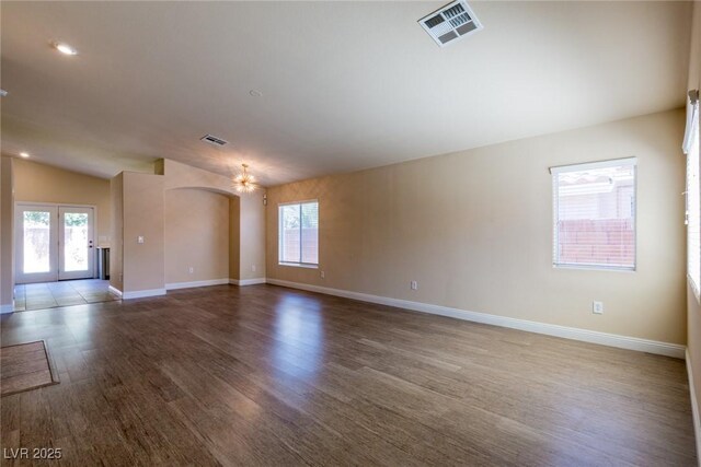 6740 Arctic Breeze St, North Las Vegas, NV 89084 - unfurnished room with wood finished floors, lofted ceiling, french doors, and a chandelier