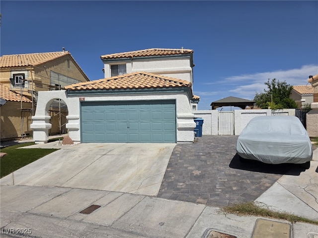 332 Dockside Ct, Las Vegas, NV 89145 - mediterranean / spanish home featuring a gate, a tiled roof, concrete driveway, stucco siding, and a garage