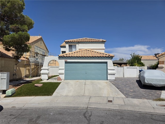 332 Dockside Ct, Las Vegas, NV 89145 - mediterranean / spanish-style home featuring a tiled roof, stucco siding, concrete driveway, and a gate