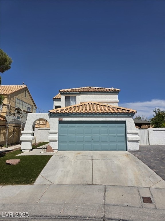 332 Dockside Ct, Las Vegas, NV 89145 - mediterranean / spanish-style house with concrete driveway, a tile roof, stucco siding, and an attached garage