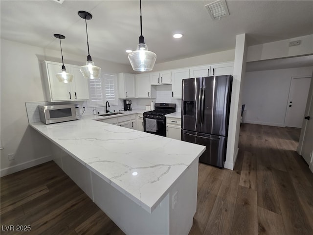 332 Dockside Ct, Las Vegas, NV 89145 - kitchen with appliances with stainless steel finishes, a peninsula, white cabinets, dark wood-style flooring, and light stone counters