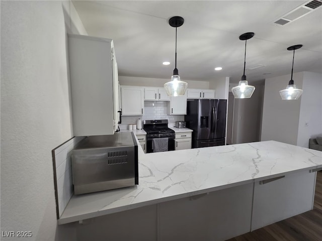 332 Dockside Ct, Las Vegas, NV 89145 - kitchen with black appliances, a peninsula, decorative backsplash, light stone counters, and recessed lighting