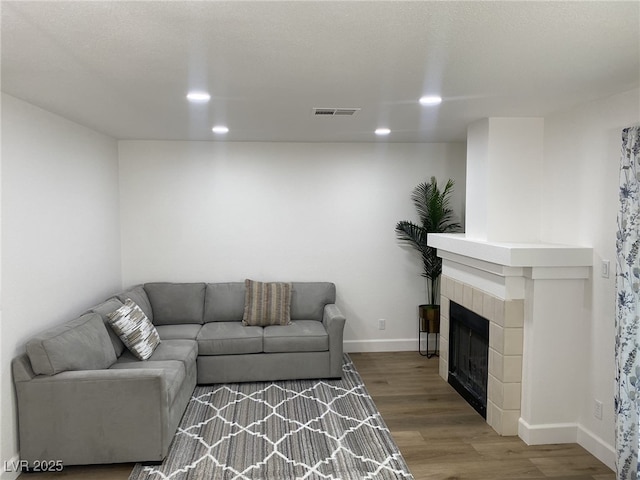 332 Dockside Ct, Las Vegas, NV 89145 - living area with wood finished floors, recessed lighting, and a tiled fireplace