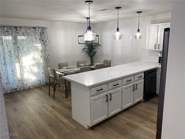 332 Dockside Ct, Las Vegas, NV 89145 - kitchen featuring a peninsula, dishwasher, dark wood-style floors, white cabinets, and light stone counters