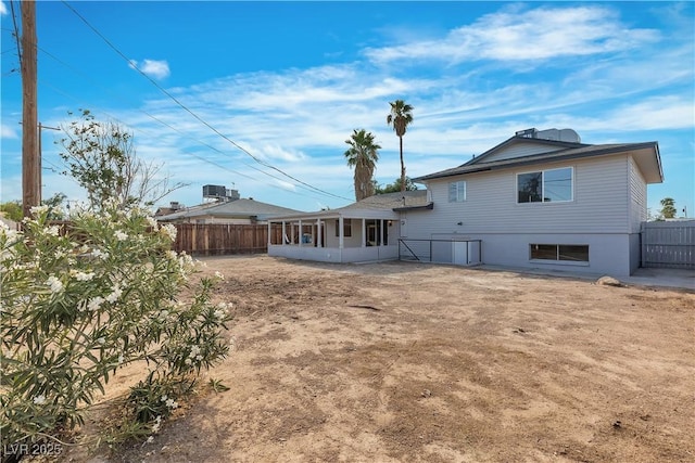 5617 Reiter Ave, Las Vegas, NV 89108 - rear view of house with a sunroom and a fenced backyard
