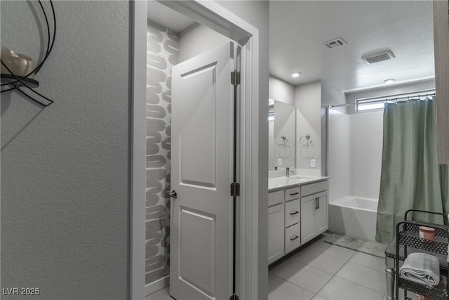 2530 Catallo St, Henderson, NV 89044 - full bathroom with vanity, tile patterned floors, a textured wall, and shower / bath combo with shower curtain
