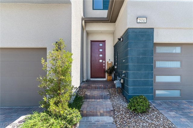 2530 Catallo St, Henderson, NV 89044 - doorway to property featuring stucco siding and a garage