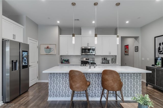 2530 Catallo St, Henderson, NV 89044 - kitchen featuring stainless steel appliances, light countertops, dark wood finished floors, tasteful backsplash, and recessed lighting