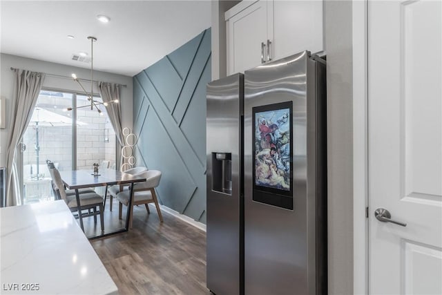 2530 Catallo St, Henderson, NV 89044 - kitchen featuring stainless steel fridge, dark wood-style flooring, decorative light fixtures, light stone countertops, and white cabinetry
