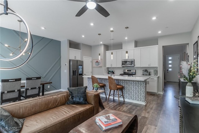 2530 Catallo St, Henderson, NV 89044 - living room featuring ceiling fan, dark wood-type flooring, a decorative wall, and recessed lighting