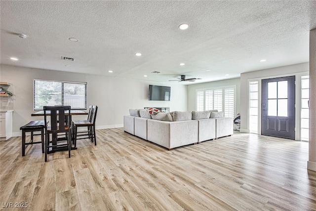 9340 W Washburn Rd, Las Vegas, NV 89149 - living area with a textured ceiling, plenty of natural light, light wood-style floors, recessed lighting, and ceiling fan