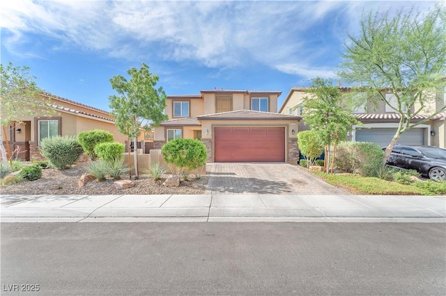 4332 Stardusk Falls Ave, North Las Vegas, NV 89084 - view of front of house with stucco siding, driveway, a garage, and stone siding
