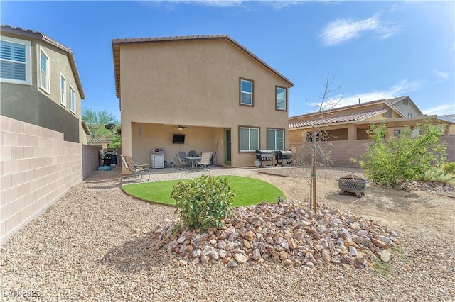 4332 Stardusk Falls Ave, North Las Vegas, NV 89084 - rear view of house featuring a fire pit, stucco siding, a fenced backyard, and a patio area