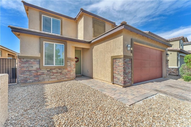 4332 Stardusk Falls Ave, North Las Vegas, NV 89084 - view of front of property with stone siding, stucco siding, an attached garage, and driveway