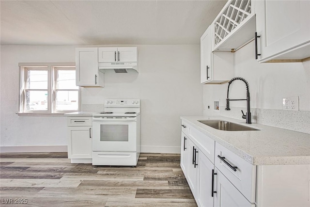 603 W Adams Ave, Las Vegas, NV 89106 - kitchen with white electric range oven, under cabinet range hood, and white cabinetry