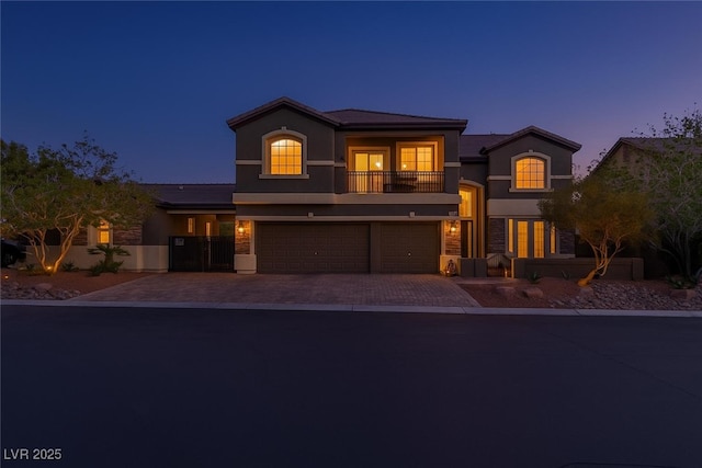 3934 Sangre De Cristo Ave, Las Vegas, NV 89118 - mediterranean / spanish home featuring a balcony, stucco siding, an attached garage, and decorative driveway