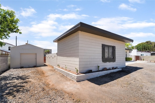 5617 Alfred Dr, Las Vegas, NV 89108 - view of home's exterior with a garage, an outbuilding, and dirt driveway