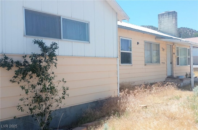 168 Lilith Ave, Pioche, NV 89043 - view of side of home featuring a metal roof and a chimney