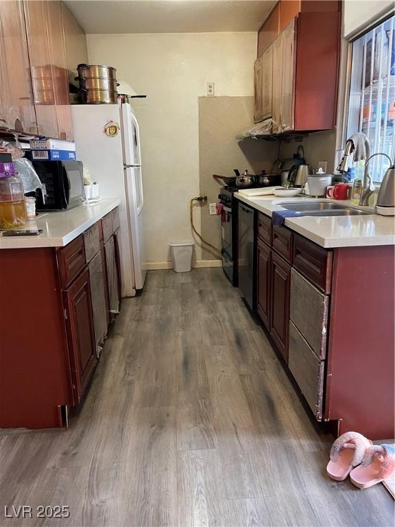 4017 Edgeford Pl, Las Vegas, NV 89102 - kitchen with wood finished floors, freestanding refrigerator, and light countertops