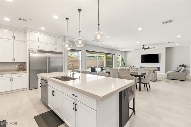 8575 Nicholas James Ave, Las Vegas, NV 89143 - kitchen featuring recessed lighting, appliances with stainless steel finishes, ceiling fan, open floor plan, and light countertops