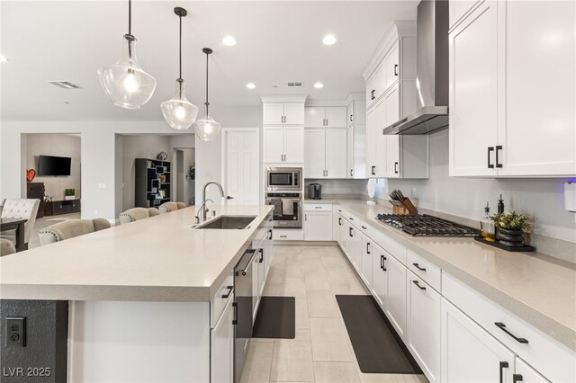 8575 Nicholas James Ave, Las Vegas, NV 89143 - kitchen with wall chimney exhaust hood, appliances with stainless steel finishes, recessed lighting, a center island with sink, and light countertops