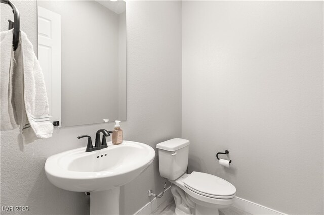 8575 Nicholas James Ave, Las Vegas, NV 89143 - half bath with baseboards and toilet