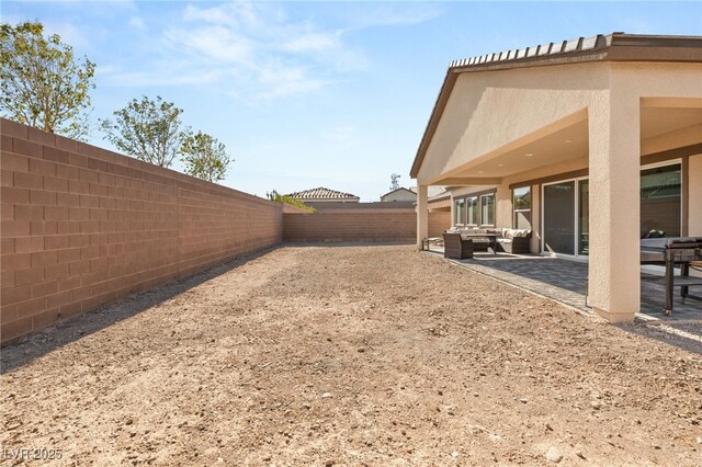 8575 Nicholas James Ave, Las Vegas, NV 89143 - fenced backyard with a patio area and an outdoor hangout area