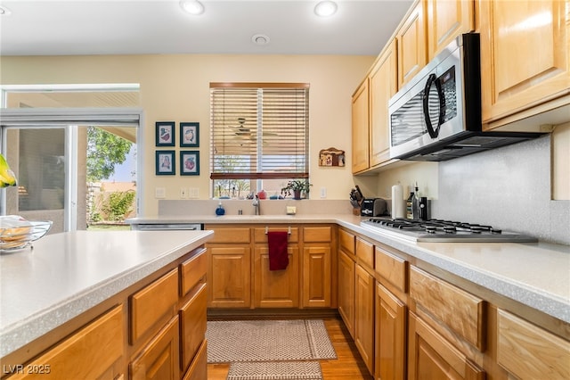 532 Kavanagh Pl, Las Vegas, NV 89123 - kitchen featuring stainless steel microwave, light countertops, light wood-style floors, gas stovetop, and recessed lighting